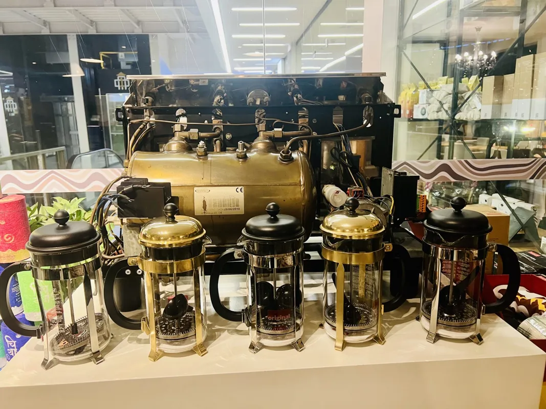 Row of French press coffee makers on display